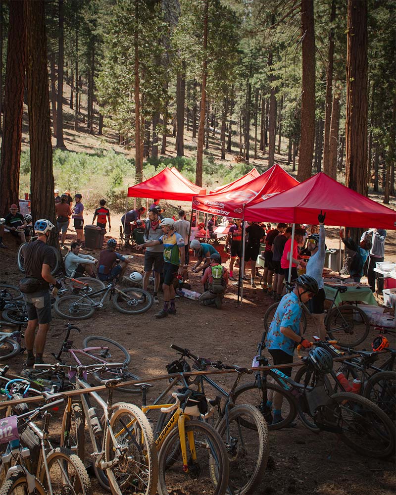Grinduro gravel bike racers riding through a mountain valley