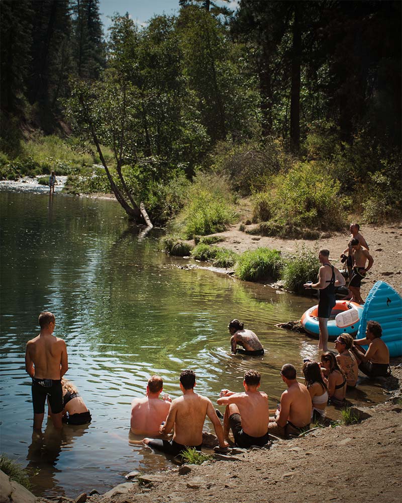 people sitting at a swimming hole