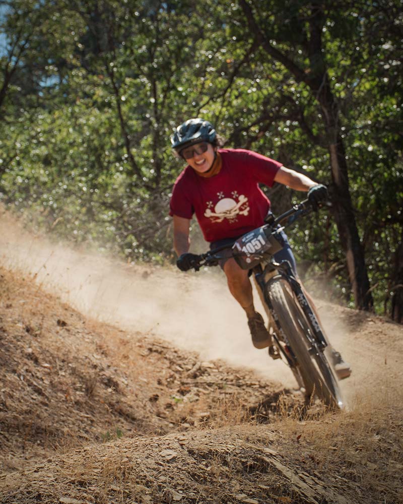 Enduro mountain bike racer smiling on a turn