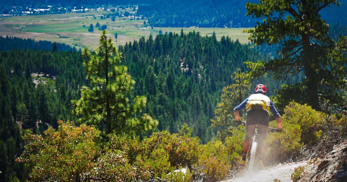 Mountain bikers racer with the town of Quincy in the background.