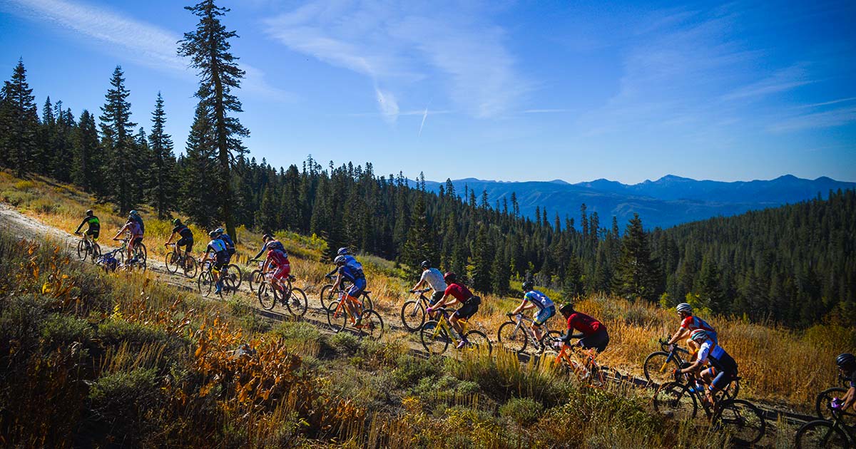 Grinduro gravel bike racers climbing to the top of the mountains